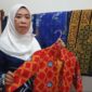 Ketua Dekranasda Lingga, Feby Sarianty saat menunjukkan motif batik Lingga yang digunakan pada seragam sekolah yang ada di Kabupaten Lingga | f. Wandy
